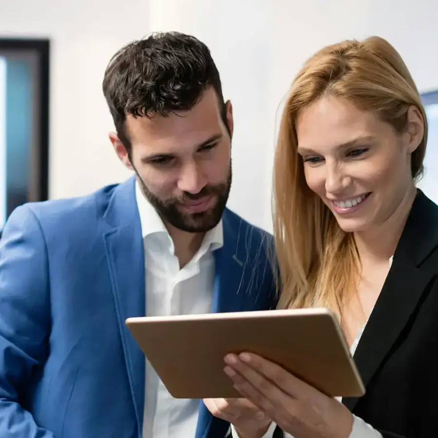 Business man and woman looking at tablet